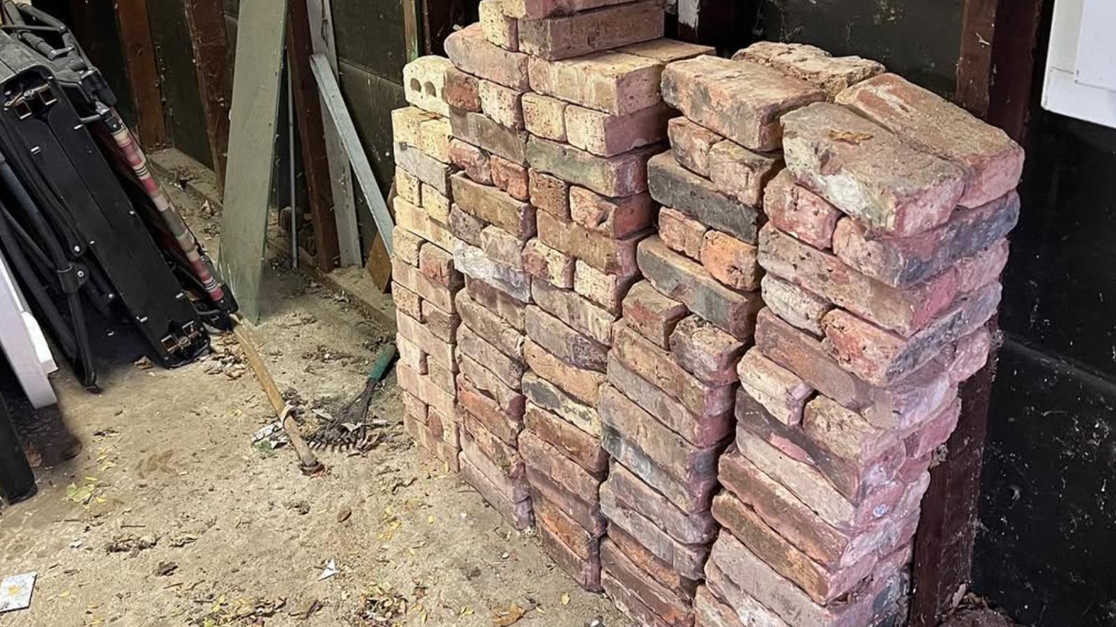 Five stacks of red bricks are waiting to be loaded and disposed of.