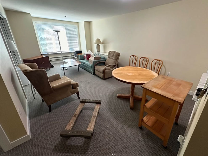 A Chicago room packed with unwanted furniture and clutter before Junk Jaws arrived.
