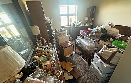 A Chicago bedroom packed floor to ceiling with boxes and clutter before a Junk Jaws hoarding cleanout