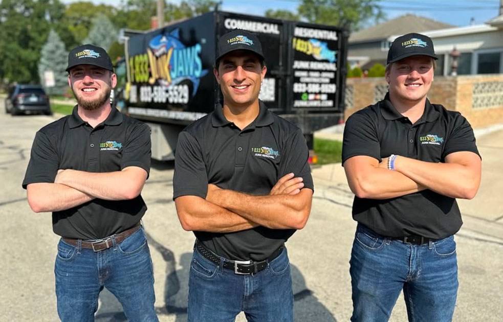 The family-owned Junk Jaws team beside a branded truck in Chicago.